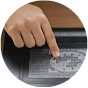 Finger pointing at tactile graphics on the DotPad